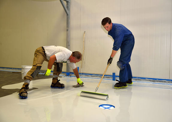 polymer coating being applied to a floor